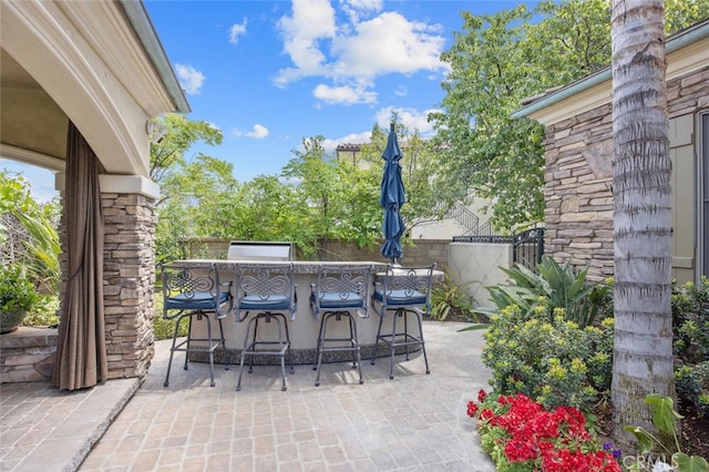 view of patio / terrace with fence and outdoor dry bar