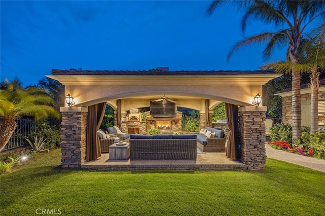 view of patio featuring an outdoor living space with a fireplace