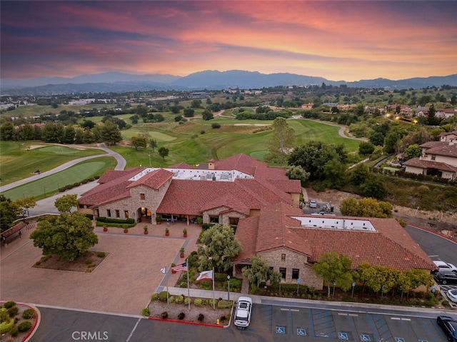 drone / aerial view featuring view of golf course and a mountain view
