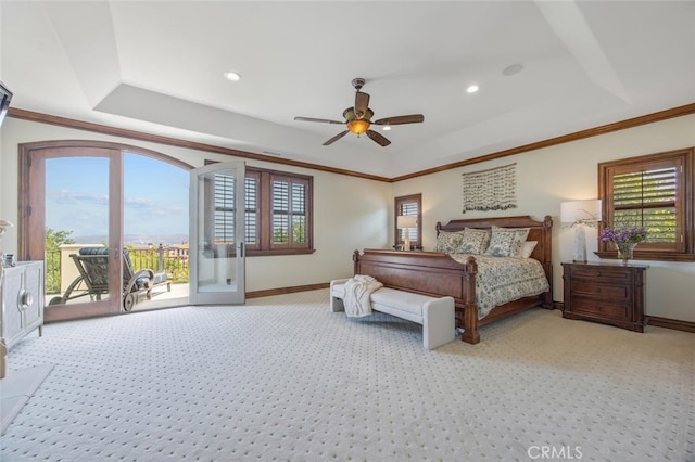 bedroom with a raised ceiling, light colored carpet, and access to exterior