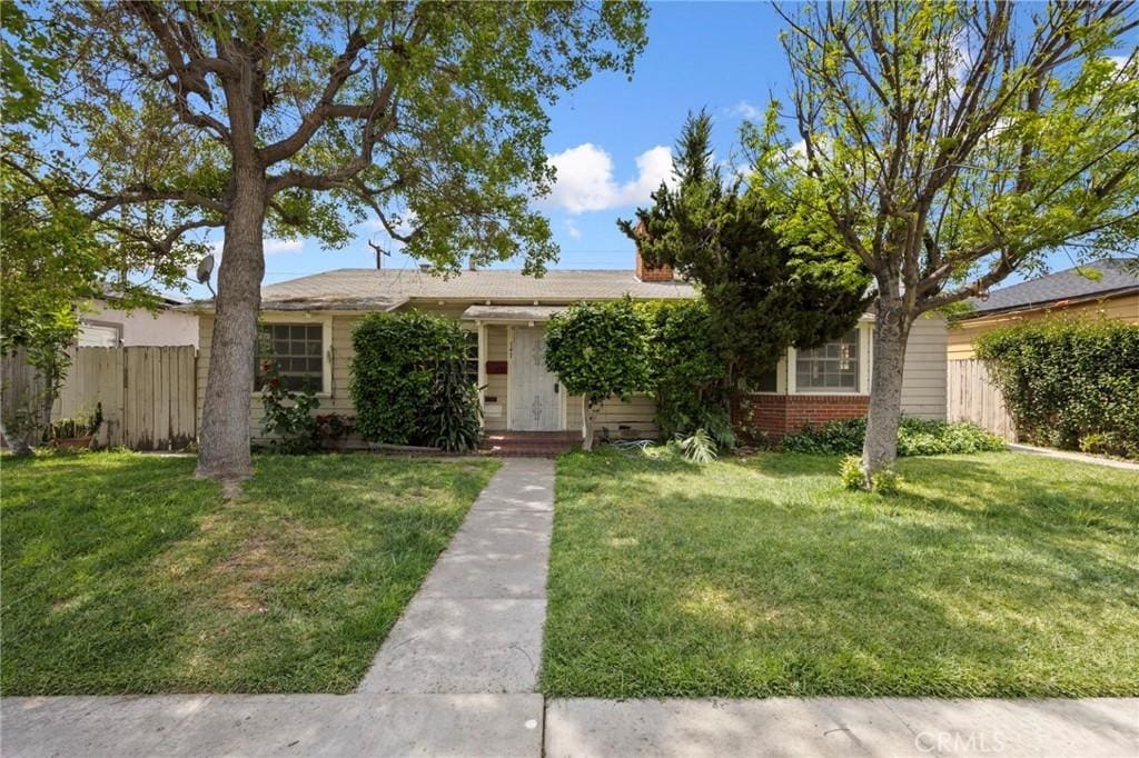 545 S Zeyn, Anaheim, CA 92805 - view of front of property with brick siding, a front lawn, and fence