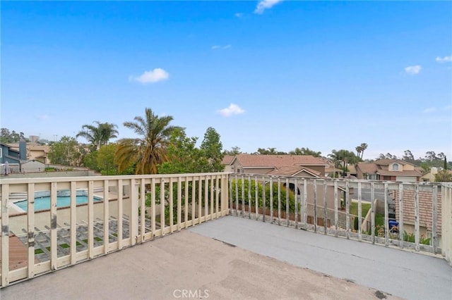 view of patio with a fenced in pool and a residential view