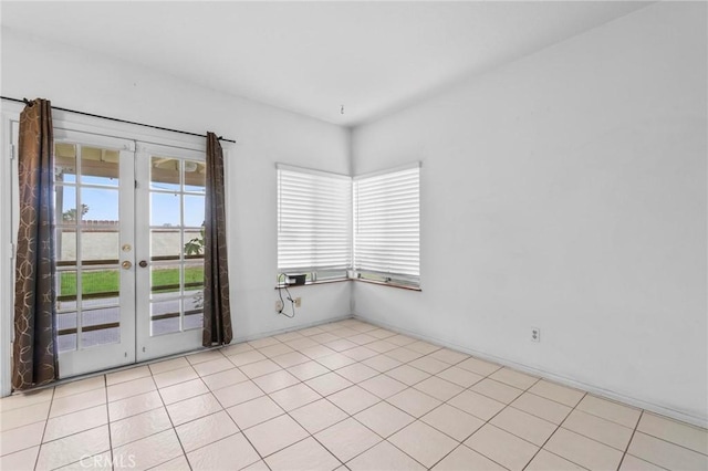 spare room with french doors and light tile patterned floors
