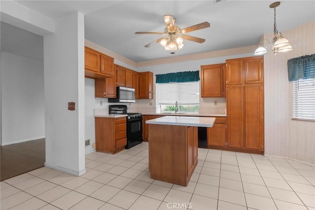 kitchen featuring light countertops, wallpapered walls, black range with gas stovetop, and brown cabinets