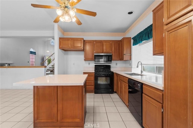 kitchen with brown cabinetry, a center island, light countertops, a sink, and black appliances
