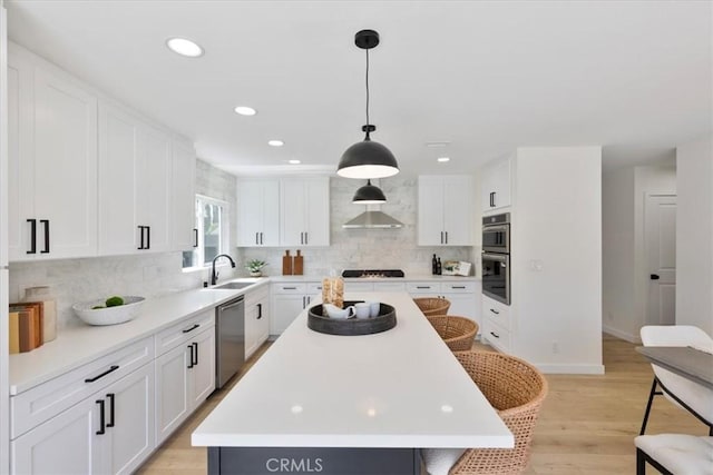 24531 Bunbury Dr, Lake Forest, CA 92630 - kitchen featuring white cabinets, stainless steel appliances, a sink, and a center island