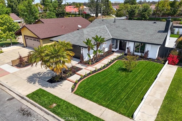 24531 Bunbury Dr, Lake Forest, CA 92630 - view of front of house with a shingled roof, a garage, stucco siding, a front yard, and driveway
