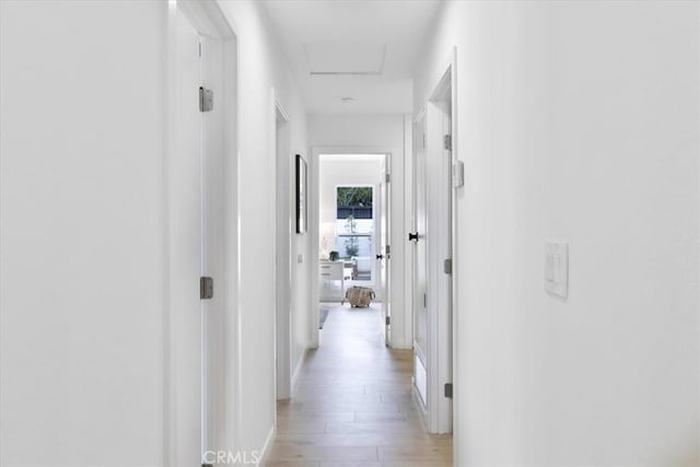 24531 Bunbury Dr, Lake Forest, CA 92630 - hallway with baseboards, attic access, and light wood-style flooring