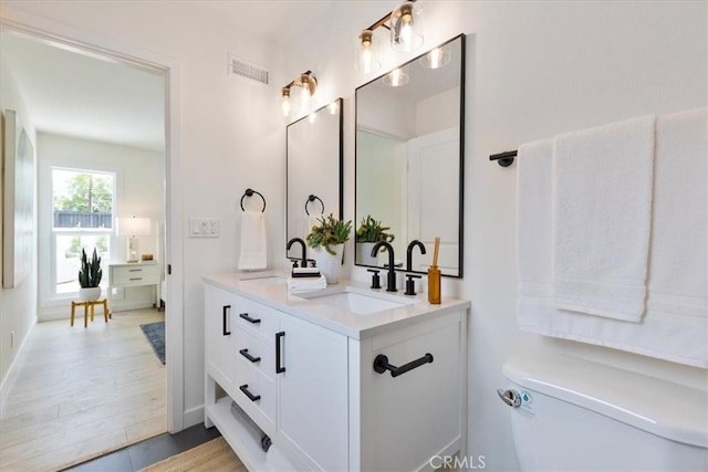 24531 Bunbury Dr, Lake Forest, CA 92630 - bathroom featuring double vanity, toilet, visible vents, and a sink