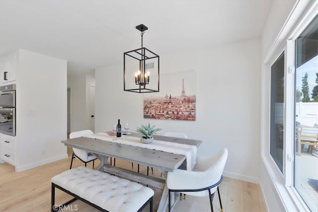 24531 Bunbury Dr, Lake Forest, CA 92630 - dining area with an inviting chandelier, baseboards, and light wood-style floors