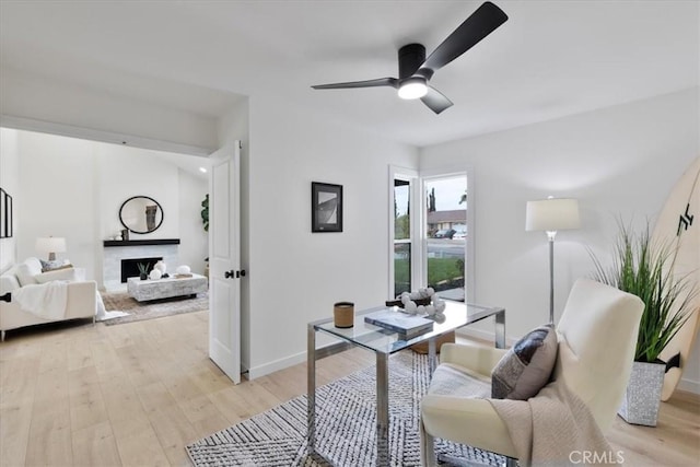 24531 Bunbury Dr, Lake Forest, CA 92630 - office area with baseboards, ceiling fan, a fireplace, and light wood-style flooring