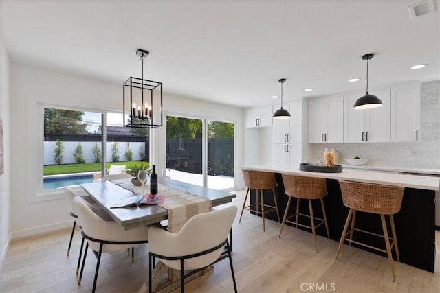 24531 Bunbury Dr, Lake Forest, CA 92630 - dining area featuring light wood-type flooring, baseboards, a notable chandelier, and visible vents
