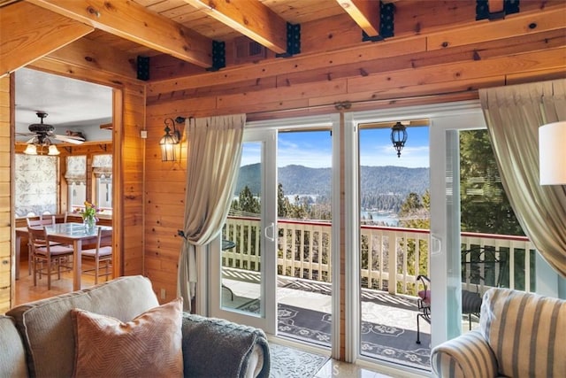27720 St Bernard Ln, Lake Arrowhead, CA 92352 - entryway featuring a mountain view, beam ceiling, wooden walls, and a healthy amount of sunlight