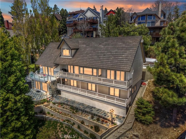 27720 St Bernard Ln, Lake Arrowhead, CA 92352 - back of property at dusk with a balcony