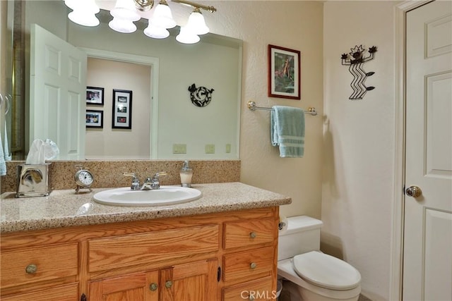 27720 St Bernard Ln, Lake Arrowhead, CA 92352 - bathroom featuring vanity, toilet, and an inviting chandelier