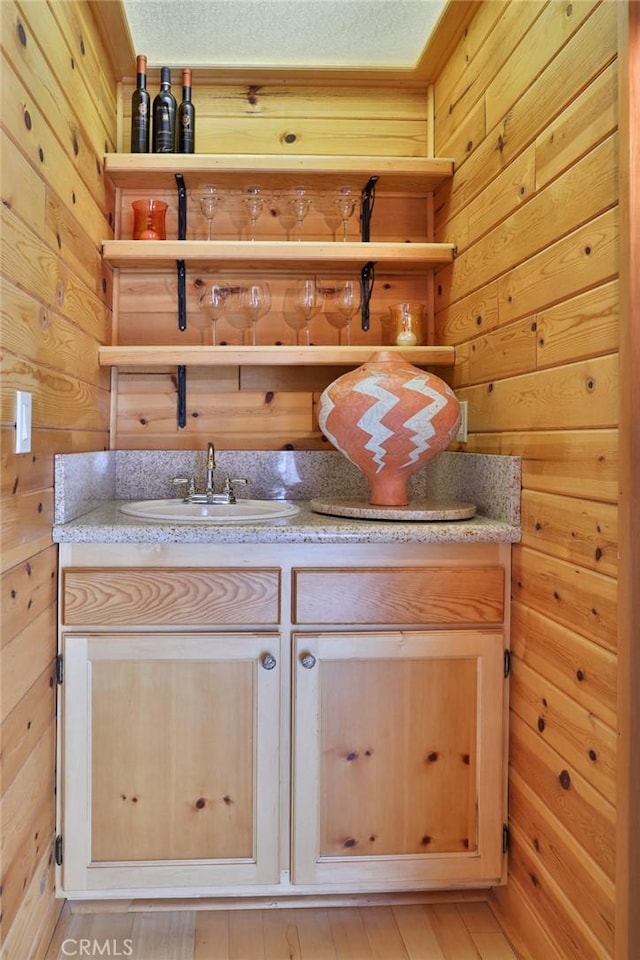 27720 St Bernard Ln, Lake Arrowhead, CA 92352 - bar featuring a sink, indoor wet bar, and wood walls