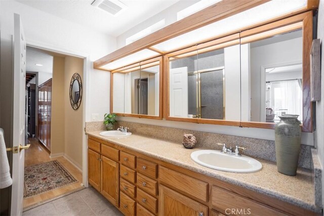 27720 St Bernard Ln, Lake Arrowhead, CA 92352 - bathroom with visible vents, a sink, double vanity, and a shower stall