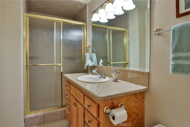 27720 St Bernard Ln, Lake Arrowhead, CA 92352 - bathroom with vanity, a textured wall, a shower stall, and a chandelier