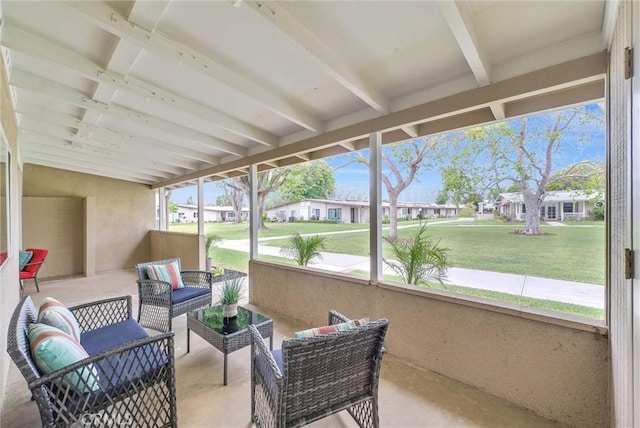 sunroom / solarium with an outdoor living space, beam ceiling, and a residential view