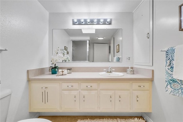bathroom with toilet and vanity