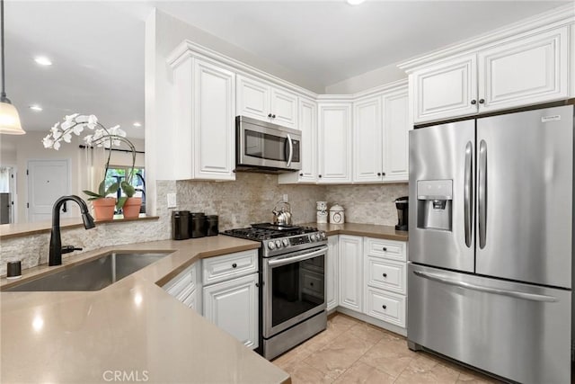 655 Via Colinas, Thousand Oaks, CA 91362 - kitchen with stainless steel appliances, a sink, white cabinetry, tasteful backsplash, and light tile patterned floors