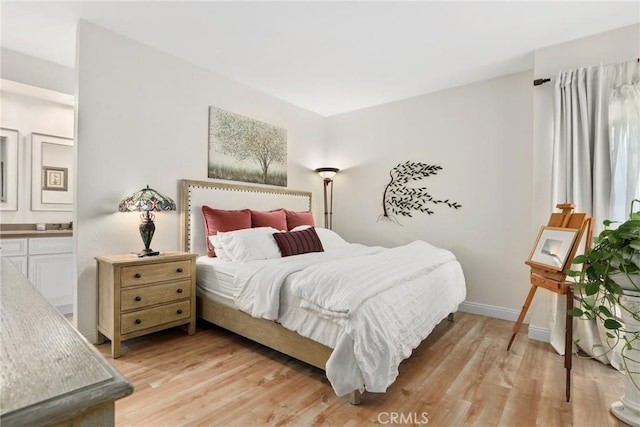 655 Via Colinas, Thousand Oaks, CA 91362 - bedroom featuring light wood-style flooring, baseboards, and connected bathroom