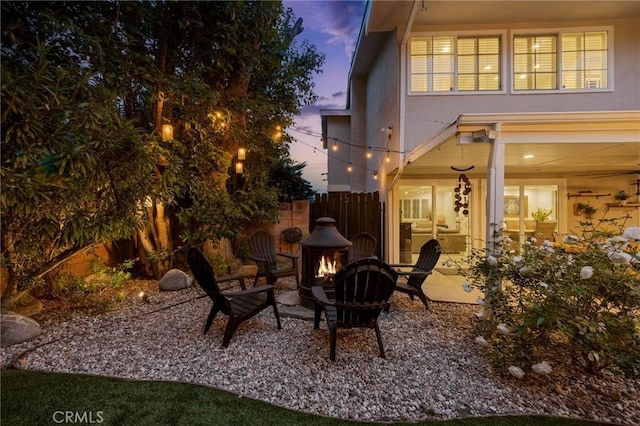 view of patio featuring fence and an outdoor fire pit