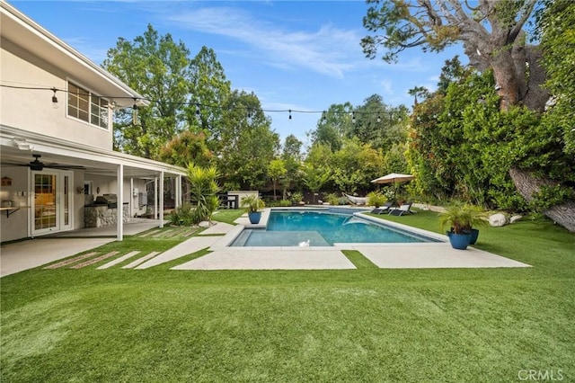 pool with a yard, a ceiling fan, and a patio area