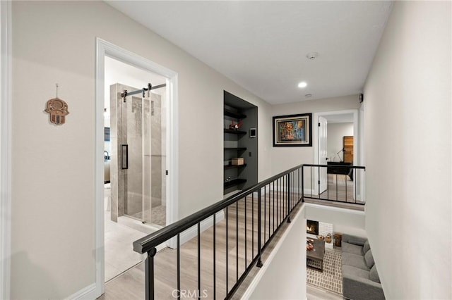 corridor with recessed lighting, baseboards, and an upstairs landing