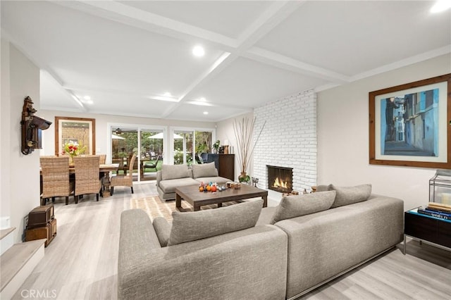 living area featuring beam ceiling, a fireplace, recessed lighting, coffered ceiling, and light wood finished floors