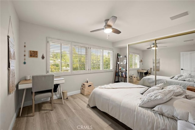bedroom featuring baseboards, a ceiling fan, light wood-type flooring, and visible vents