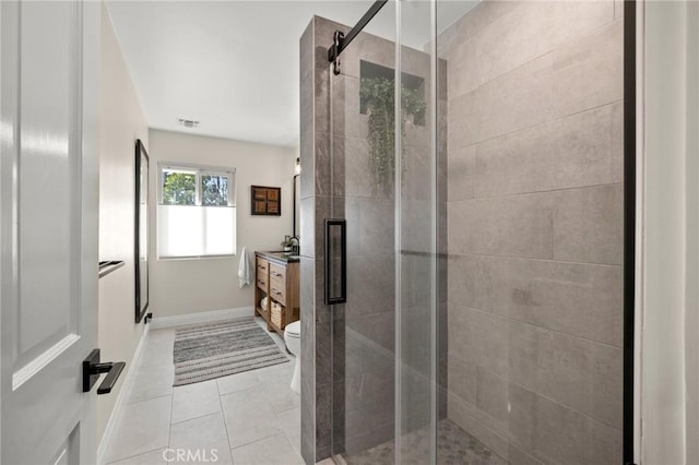 full bath with toilet, a shower stall, tile patterned flooring, and vanity