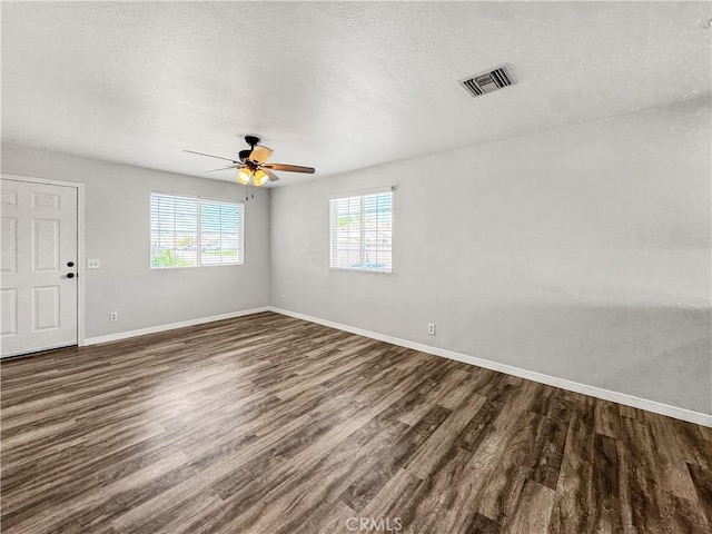 509 Kristi Ln, Blythe, CA 92225 - unfurnished room featuring a textured ceiling, baseboards, visible vents, and dark wood-type flooring