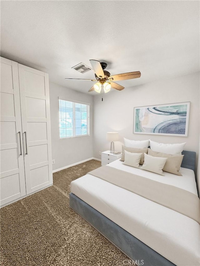 509 Kristi Ln, Blythe, CA 92225 - bedroom with visible vents, baseboards, ceiling fan, and dark colored carpet