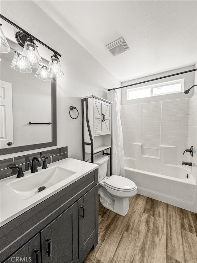 509 Kristi Ln, Blythe, CA 92225 - bathroom with vanity, toilet, shower / bath combination with curtain, wood finished floors, and visible vents