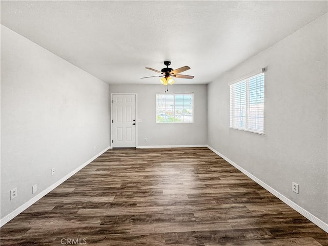 509 Kristi Ln, Blythe, CA 92225 - empty room featuring ceiling fan, dark wood finished floors, and baseboards