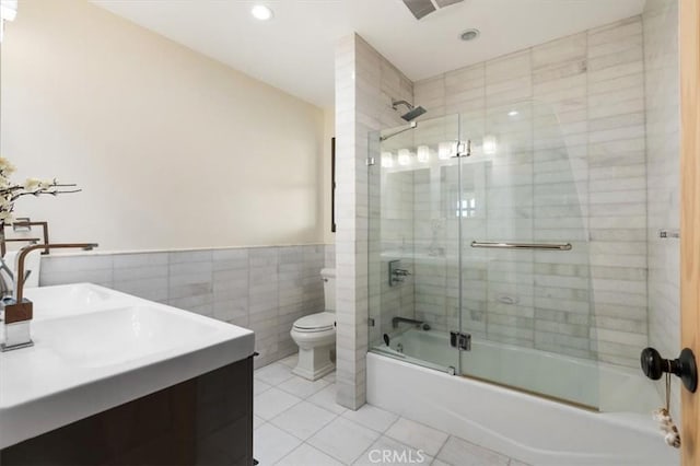 30140 Tuttle Ct, Tehachapi, CA 93561 - bathroom with tile walls, wainscoting, tile patterned floors, combined bath / shower with glass door, and toilet