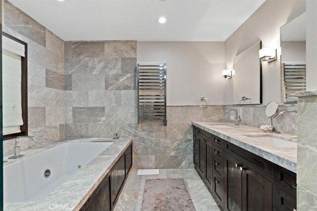 30140 Tuttle Ct, Tehachapi, CA 93561 - bathroom featuring double vanity, tile walls, a sink, a whirlpool tub, and radiator
