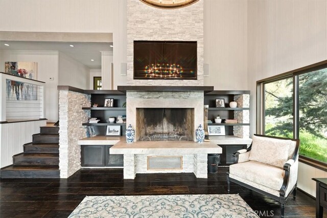 30140 Tuttle Ct, Tehachapi, CA 93561 - living room featuring a fireplace with raised hearth, hardwood / wood-style flooring, and a towering ceiling