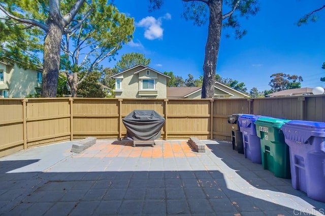 view of patio / terrace with fence and a grill