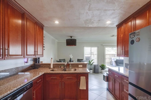 kitchen with crown molding, dark brown cabinets, a sink, stainless steel appliances, and a peninsula