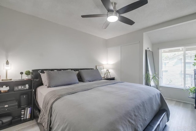 bedroom featuring baseboards, ceiling fan, and wood finished floors