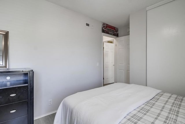 bedroom with visible vents and wood finished floors