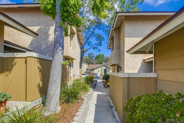 view of home's exterior featuring fence and stucco siding