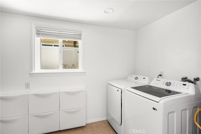 washroom featuring baseboards, separate washer and dryer, laundry area, and light tile patterned floors