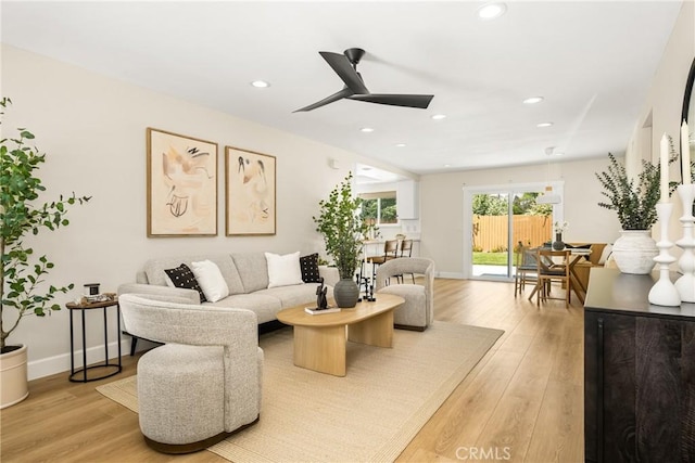 living area with light wood-style floors, recessed lighting, baseboards, and ceiling fan