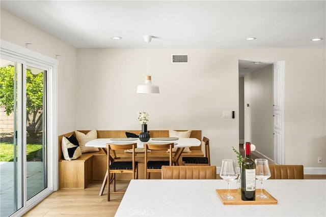 dining area with light wood-style floors, recessed lighting, and visible vents