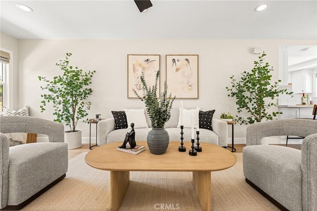 living area with recessed lighting, light wood-style flooring, and baseboards
