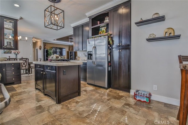 3595 Santa Fe Ave, Long Beach, CA 90810 - kitchen featuring open shelves, baseboards, stainless steel fridge, tile countertops, and a notable chandelier