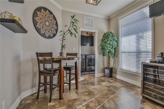 3595 Santa Fe Ave, Long Beach, CA 90810 - dining area featuring stone finish flooring, visible vents, crown molding, baseboards, and wine cooler